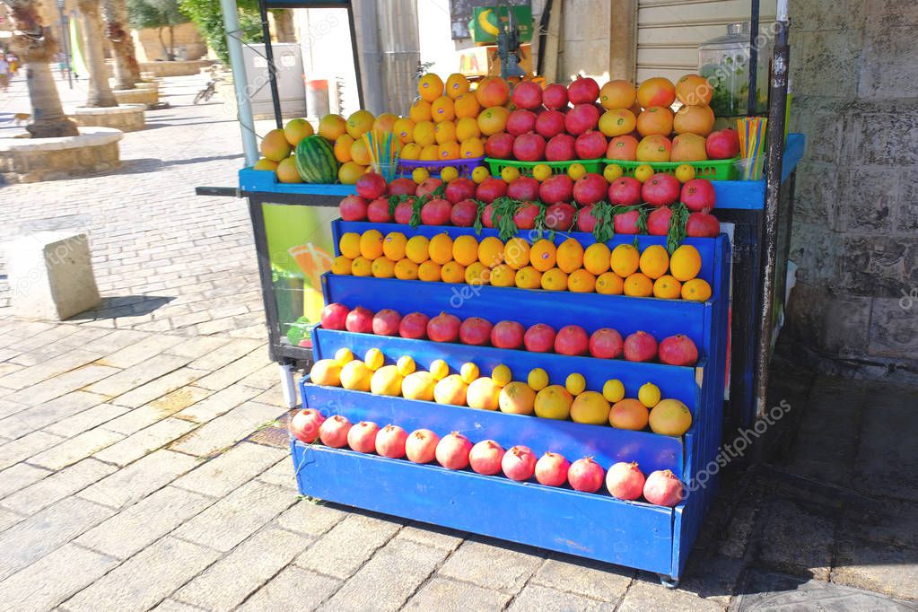 street market tray fruit citrus oranges pomegranate tourists travel sea israel acre