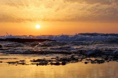 günbatımı ve gökyüzü ve deniz ve dalgalar ve Akdeniz'de İsrail üzerinde bulutlar