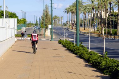 İsrail - Netanya, 12 Ekim 2017: kaldırımda binmek bisiklet kask içinde adam