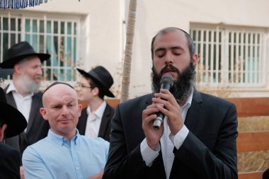 ISRAEL - Netanya, 23 May 2019: a jewish elderly rabbi with a beard sings a song