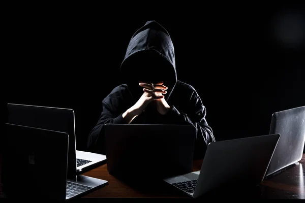 Hacker in front of his computer. Dark face