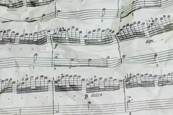 Old crumpled music sheet, closeup