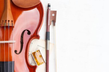Part of the violin, bow and rosin isolated on a white background. clipart