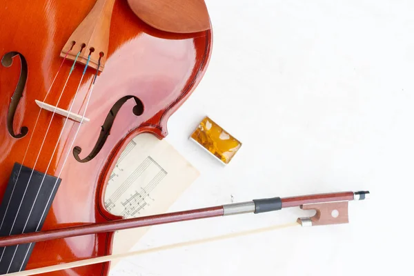 Part of the violin, bow and rosin isolated on a white background.