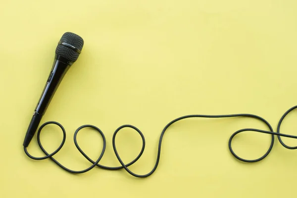 Microphone for blogger, journalist or musician work on yellow background. karaoke microphone. top view mock up top view space for text — Stock Photo, Image