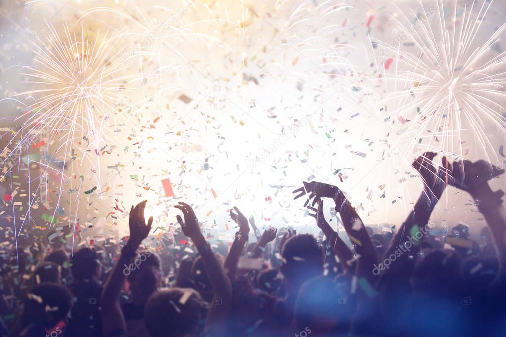 Crowd with Fireworks. New Years Eve concept or Music Festival theme. 