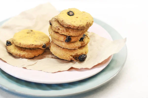 Cookies with raisins on a plate. Serving with Kraft paper.