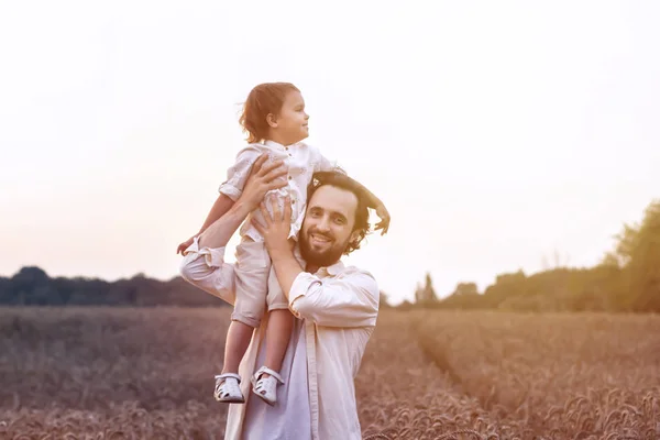 father\'s day. Dad and son playing together outdoors on a summer. Happy family, father, son at sunset. The concept of organic farming and healthy lifestyle,  happiness and joy