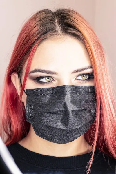 Young girl in medical mask, gloves and syringe. Fashion for medical dressings among young people. The concept of cosmetic services, injections, Botox, modern fashion to wear medical masks — Stock Photo, Image