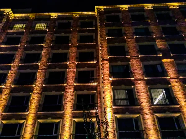 Hotel building with windows and lights at night