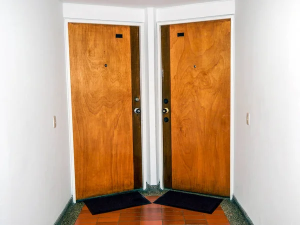 Hallway with two wooden apartment doors