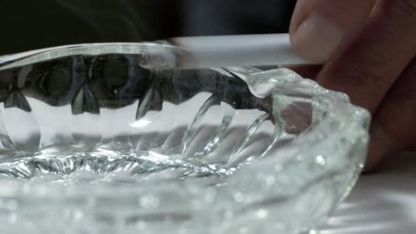 Gros plan de la main d'un fumeur à l'aide du cendrier. fumeur mettre la cigarette dans le cendrier 