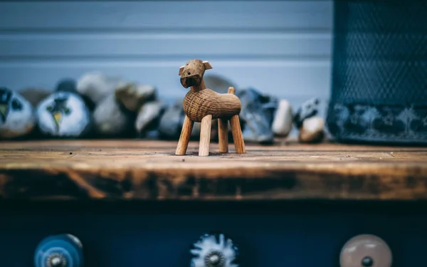 A set up picture, of a wooden dog made by the danish designer \