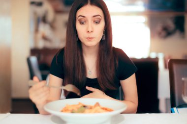Woman Feeling Sick While Eating Bad Food in a Restaurant clipart