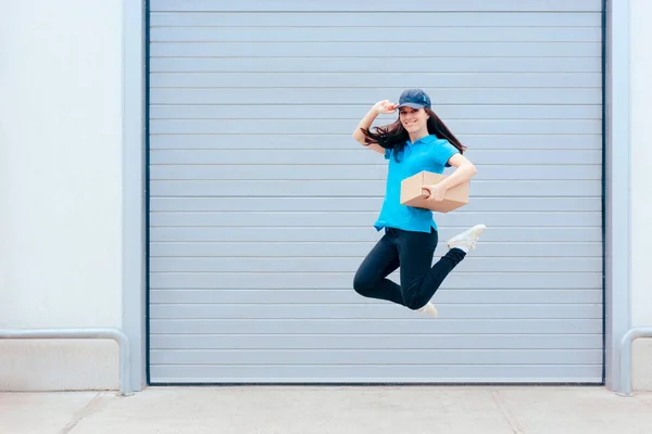 Female Delivery Worker Jumping Front Storage Warehouse — Stock Photo, Image