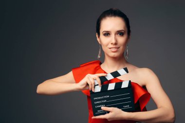 Elegant Actress in Red Dress Holding Cinema Clapboard clipart