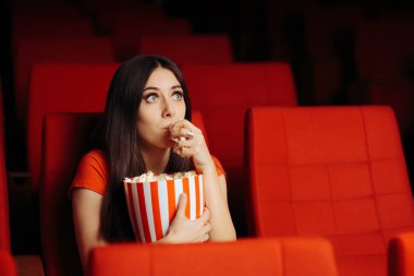 Funny Girl with Popcorn Watching Movie in Cinema Theatre clipart