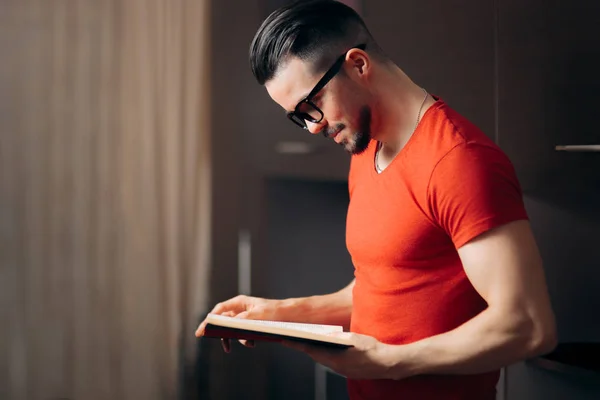 Homem Bonito Lendo Livro Casa Relaxante — Fotografia de Stock