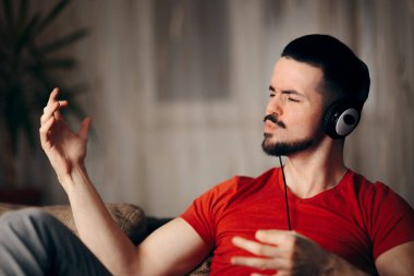 Funny Man Listening to Music Doing Air Guitar Gesture clipart