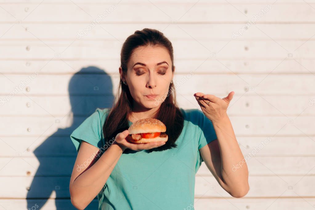 Woman Evaluating Quality of Burger By its Smell 