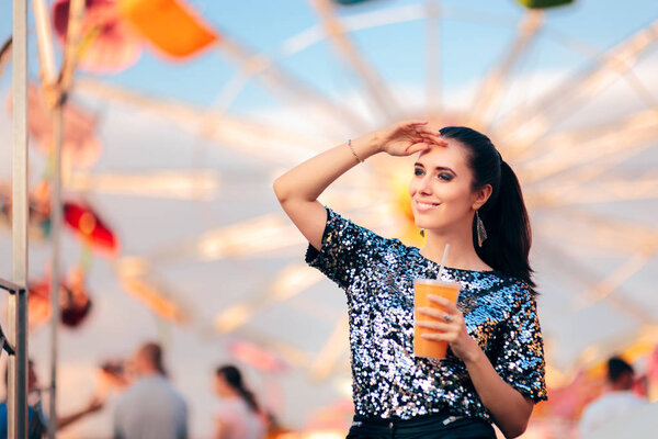 Woman with Juice on Spinning Ferris Wheel Background