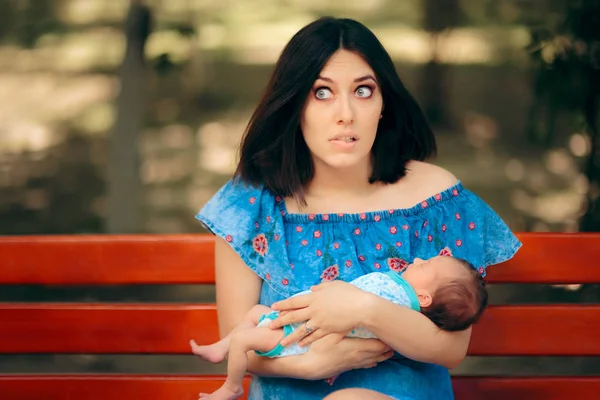 Stressed Mother Holding Newborn Baby in Her Arms