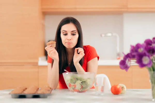 Woman Eating Cupcake Instead Apples Salad — Stock Photo, Image