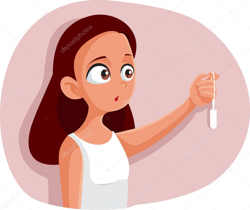Teen Girl Experiencing First Menstruation Holding a Tampon
