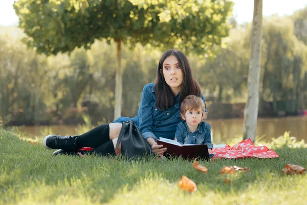 Tired Mother Reading a Book to Her Daughter