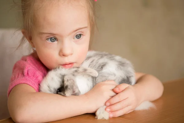 唐氏综合症女孩拥抱兔子 — 图库照片