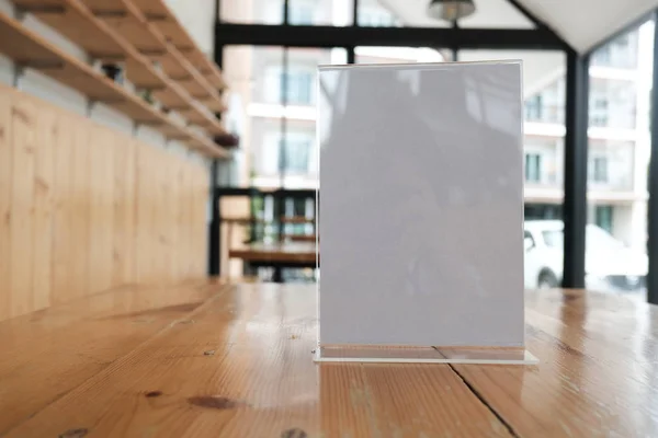 white label in cafe. display stand for acrylic tent card in coffee shop. mockup menu frame on table in bar restaurant. space for text