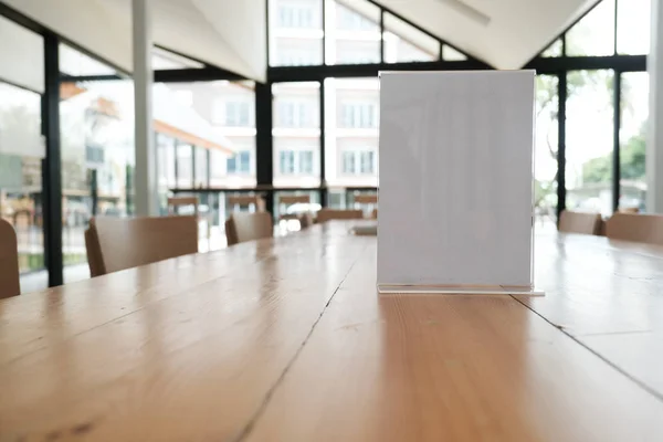 white label in cafe. display stand for acrylic tent card in coffee shop. mockup menu frame on table in bar restaurant. space for text