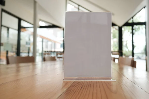 white label in cafe. display stand for acrylic tent card in coffee shop. mockup menu frame on table in bar restaurant. space for text