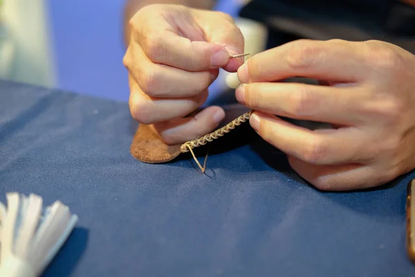 craftsman sewing making leather bag. handmade DIY handicraft workshop