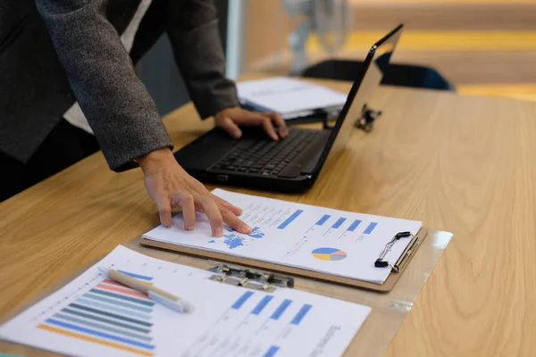 financial inspector analyze sales document at office. businesswoman working with computer at workplace