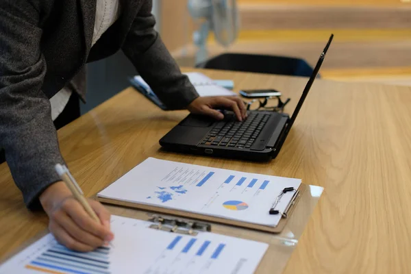 financial inspector analyze sales document at office. businesswoman working with computer at workplace