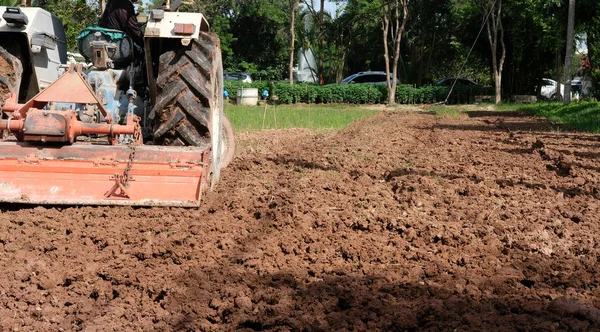 farmer in tractor preparing field for seedling. agriculture work at farm land