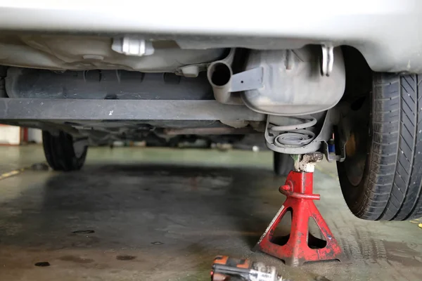 car lift up for shock absorber & spring replacement in auto service repair garage