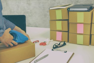 İşyerinde karton kutu ambalaj başlangıç küçük işletme sahibi. serbest kadın girişimci satıcı parsel kutusu, ürünün müşteriye teslim için hazırlayın. Online satış, e-ticaret kavramı