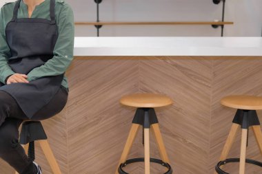 Cafe kahve salonu kafeterya Restoran sayaç barda oturan önlük giyen işletme sahibi