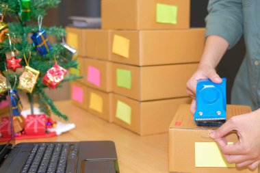 İşyerinde karton kutu ambalaj başlangıç küçük işletme sahibi. serbest adam girişimci satıcı parsel kutusu, ürünün müşteriye teslim için hazırlayın. Online satış, e-ticaret kavramı