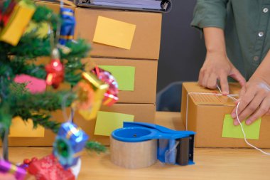 İşyerinde karton kutu ambalaj başlangıç küçük işletme sahibi. serbest adam girişimci satıcı ürün parsel kutusu müşteriye teslim için hazırlayın. Online satış, e-ticaret kavramı