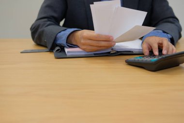 adam aile içi faturaları hesaplayın. Denge ve maliyetleri kontrol hesap makinesini kullanarak iş adamı. Ofisinde vergi ödeme için finans sayma başlangıç