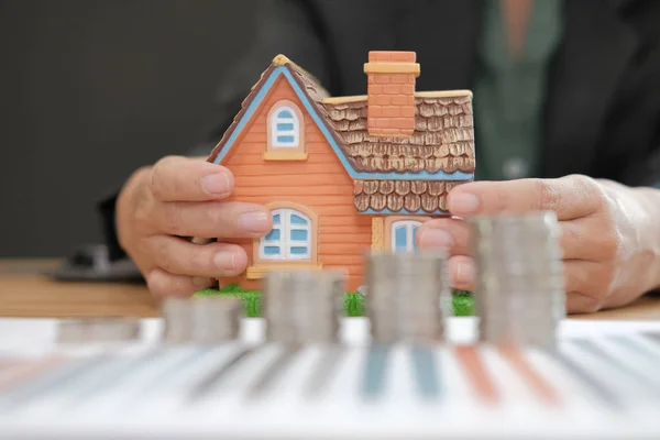 house model & coins stack. saving money for buying house property. real estate investment finance & banking