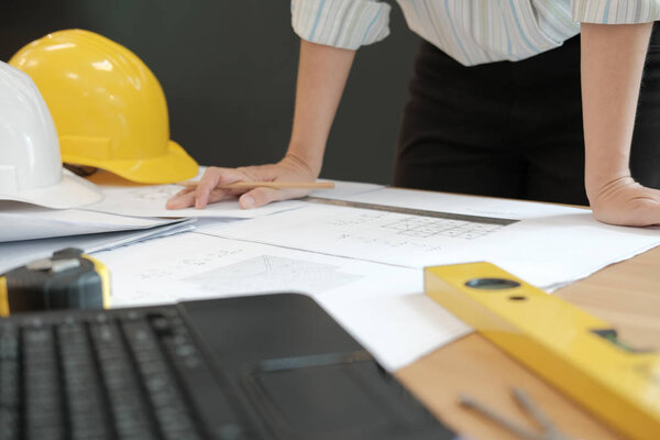 architect engineer working on house blueprint of real estate project at workplace. construction & building concept