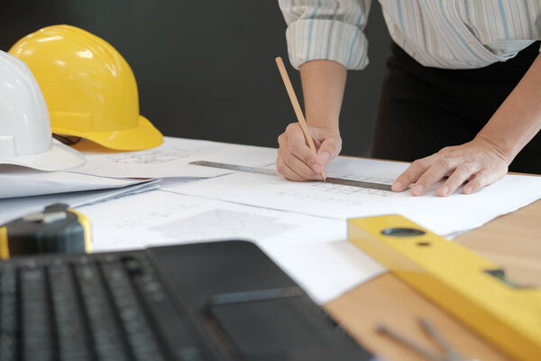 architect engineer working on house blueprint of real estate project at workplace. construction & building concept