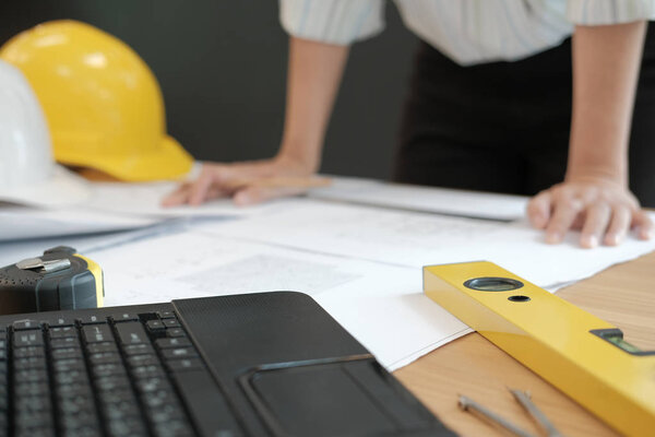 architect engineer working on house blueprint of real estate project at workplace. construction & building concept