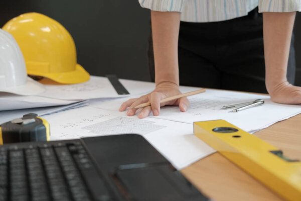 architect engineer working on house blueprint of real estate project at workplace. construction & building concept