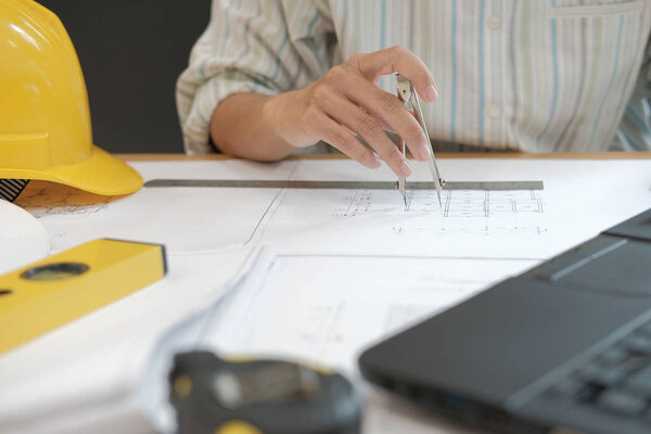 architect engineer working on house blueprint of real estate project at workplace. construction & building concept