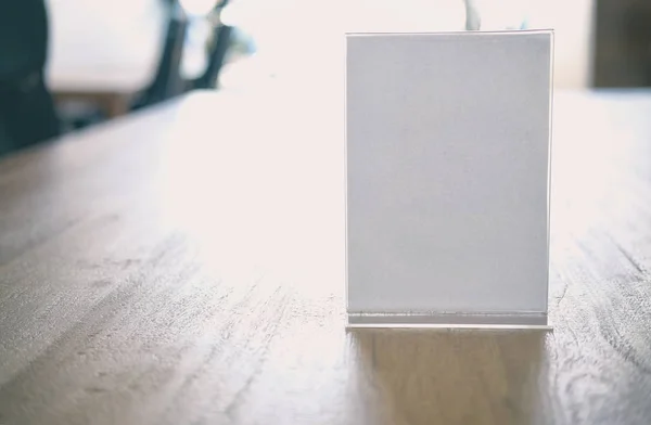 white label in cafe. display stand for acrylic tent card in coffee shop. mockup menu frame on table in restaurant. space for text